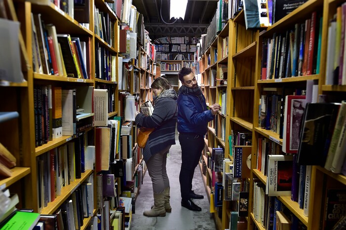 (Scott Sommerdorf | The Salt Lake Tribune)
Sarah Hollenberg and Ian Burnley looked for books on Small Business Saturday at Ken Sanders Rare Books, Saturday, November 25, 2017.