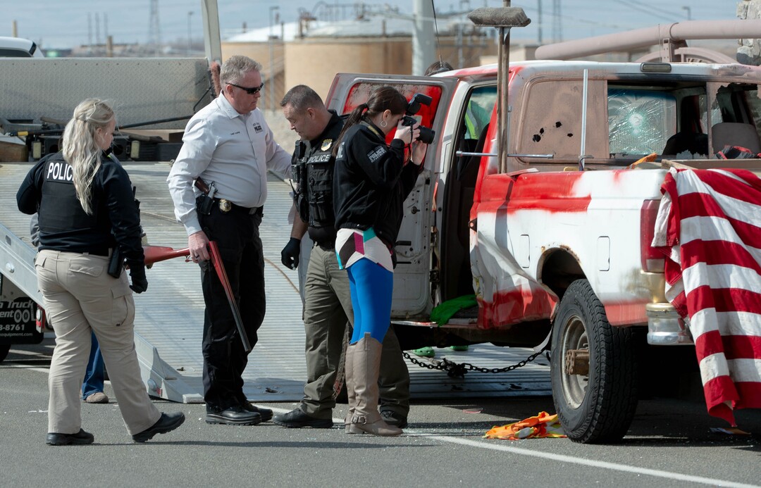 (Francisco Kjolseth  | The Salt Lake Tribune) Investigators remove a double barrel shotgun from a vehicle as numerous police agencies respond to a man driving erratically and claiming to have a gun and a bomb with an initial police chase ending on Center Street over Legacy Highway on Wednesday, March 17, 2021. The suspect was taken into custody.