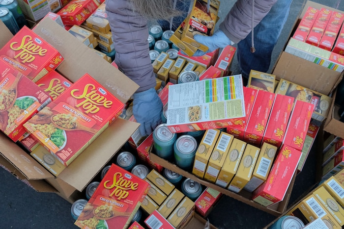 (Leah Hogsten | The Salt Lake Tribune) Volunteers hand out food from the Utah Food Bank to needy families, Dec. 23, 2020.