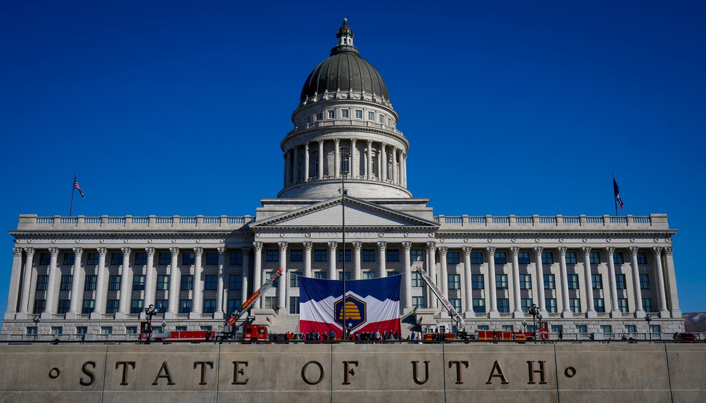 (Bethany Baker  |  The Salt Lake Tribune) Utah's new Beehive Flag is hoisted up between two fire trucks on the steps of the Utah Capitol in Salt Lake City on Saturday, March 9, 2024.