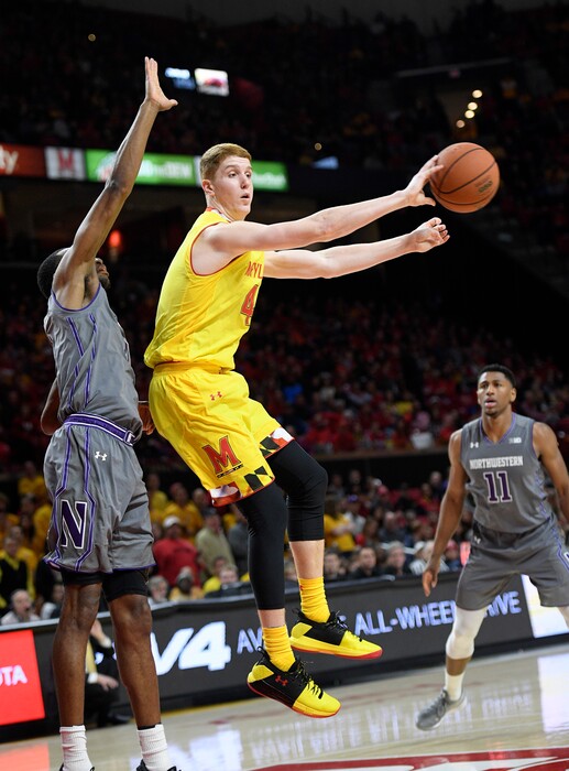 Maryland guard Kevin Huerter (4) passes the ball against Northwestern forward Vic Law, left, and guard Anthony Gaines (11) during the second half of an NCAA basketball game, Saturday, Feb. 10, 2018, in College Park, Md. Maryland won 73-57. (AP Photo/Nick Wass)