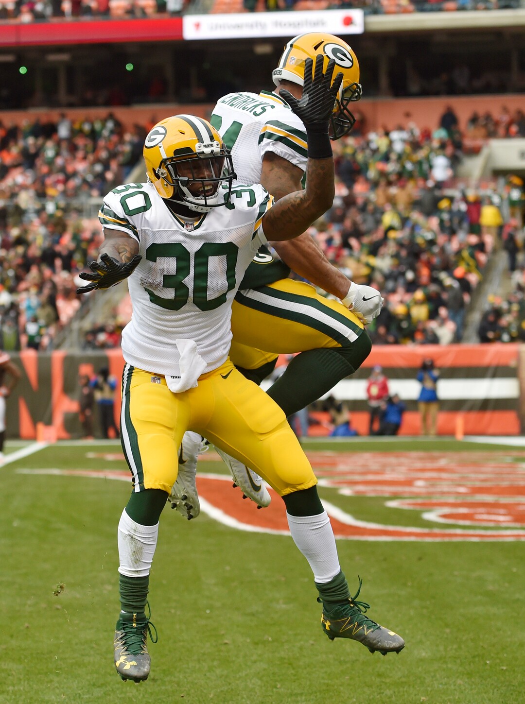 Green Bay Packers running back Jamaal Williams (30) celebrates with tight end Lance Kendricks (84) after Williams scored on a 30-yard touchdown pass in the first half of an NFL football game against the Cleveland Browns, Sunday, Dec. 10, 2017, in Cleveland. (AP Photo/David Richard)