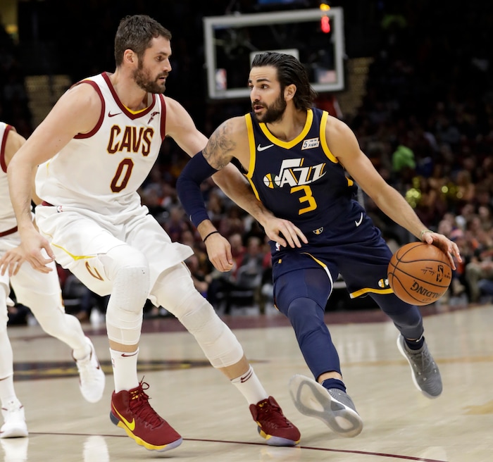 Utah Jazz's Ricky Rubio (3), from Spain, drives past Cleveland Cavaliers' Kevin Love (0) in the first half of an NBA basketball game, Saturday, Dec. 16, 2017, in Cleveland. (AP Photo/Tony Dejak)
