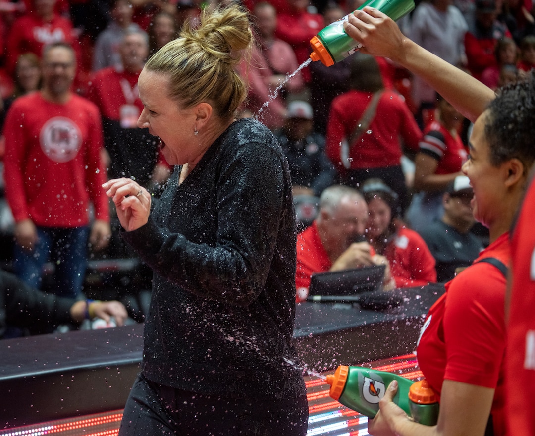 (Rick Egan | The Salt Lake Tribune) Ute players spray water on Utah Head Coach Lynne Roberts, as they celebrate the Utes 84-78 win over the Stanford Cardinals, in PAC-12 action, at the Jon M. Huntsman Center, on Saturday, Feb. 25, 2023.