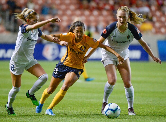 (Francisco Kjolseth  |  The Salt Lake Tribune)  Utah Royals FC forward Christen Press (23) gets pressured by North Carolina Courage midfielder Denise O'Sullivan (8) and North Carolina Courage midfielder Samantha Mewis (5) as Utah Royals FC hosts the North Carolina Courage at Rio Tinto Stadium in Sandy, Utah on Saturday, July 27, 2019.