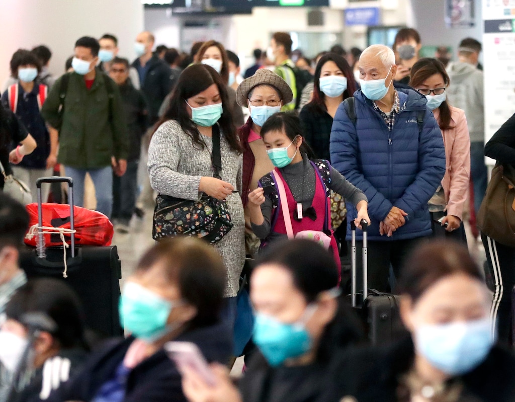 (Achmad Ibrahim | AP) Passengers wearing protective face masks enter the departure hall of a high speed train station in Hong Kong, Friday, Jan. 24, 2020. China expanded its lockdown against the deadly new virus to an unprecedented 36 million people and rushed to build a prefabricated, 1,000-bed hospital for victims Friday as the outbreak cast a pall over Lunar New Year, the country's biggest, most festive holiday..