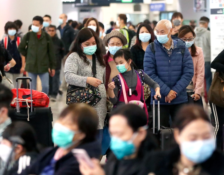 (Achmad Ibrahim | AP) Passengers wearing protective face masks enter the departure hall of a high speed train station in Hong Kong, Friday, Jan. 24, 2020. China expanded its lockdown against the deadly new virus to an unprecedented 36 million people and rushed to build a prefabricated, 1,000-bed hospital for victims Friday as the outbreak cast a pall over Lunar New Year, the country's biggest, most festive holiday..
