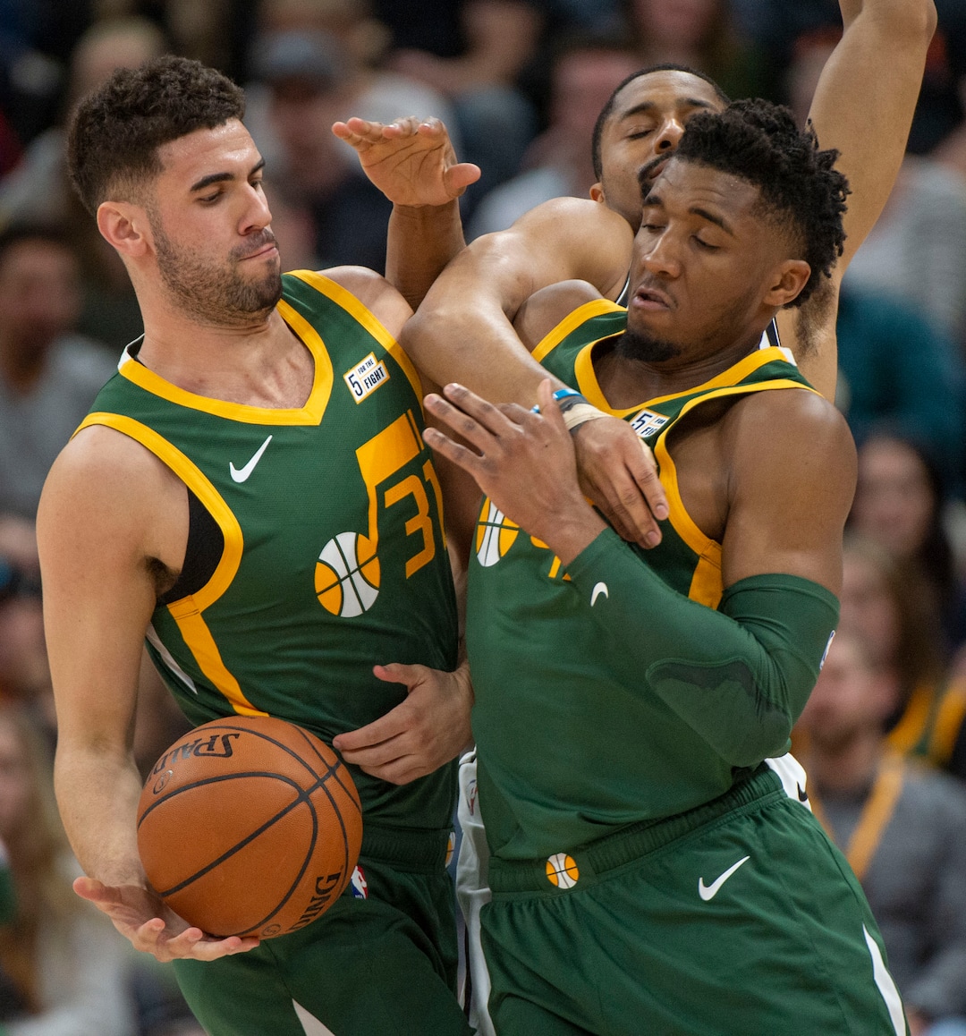 (Rick Egan  |  The Salt Lake Tribune)  Brooklyn Nets guard Spencer Dinwiddie (8) tries to keep the ball from Utah Jazz guard Donovan Mitchell (45) as he takes a hand off from Utah Jazz forward Georges Niang (31), in NBA action between Utah Jazz and Brooklyn Nets, at  Vivint Smart Home Arena, Saturday, March 17, 2019.