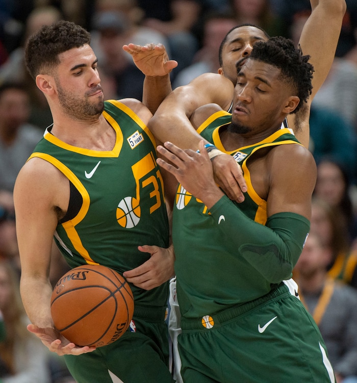 (Rick Egan  |  The Salt Lake Tribune)  Brooklyn Nets guard Spencer Dinwiddie (8) tries to keep the ball from Utah Jazz guard Donovan Mitchell (45) as he takes a hand off from Utah Jazz forward Georges Niang (31), in NBA action between Utah Jazz and Brooklyn Nets, at  Vivint Smart Home Arena, Saturday, March 17, 2019.



