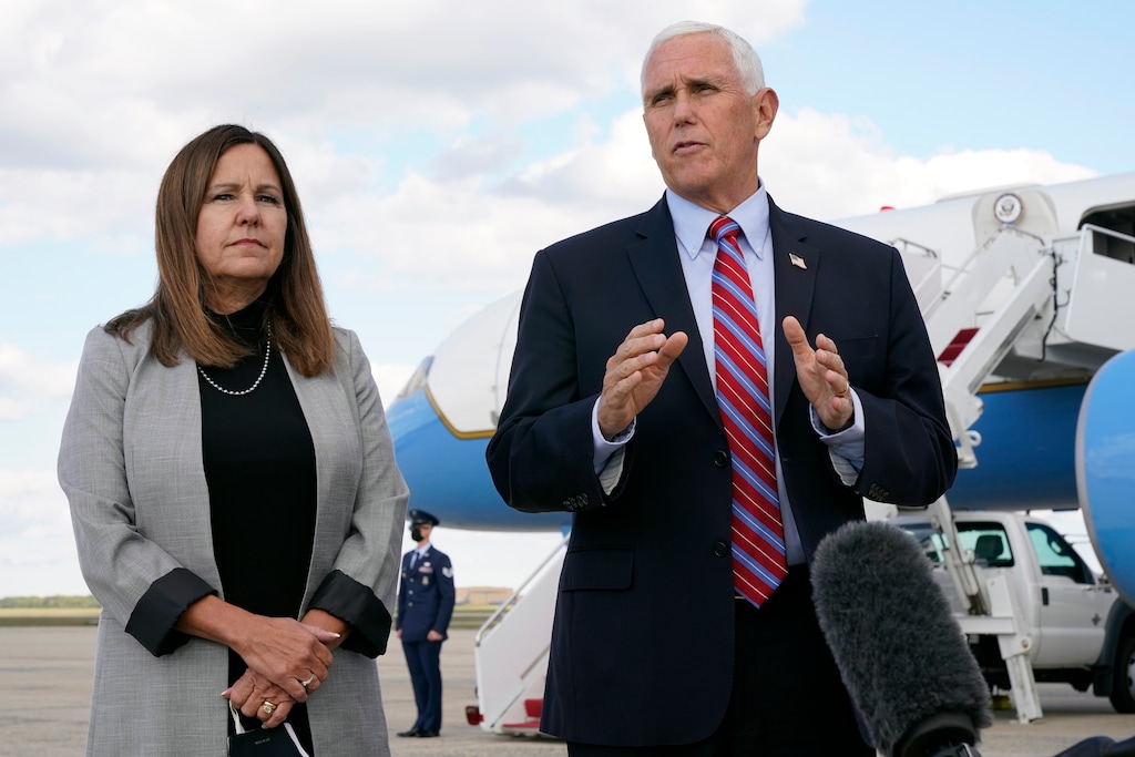 (Jacquelyn Martin | AP photo) Vice President Mike Pence speaks to members of the new media at Andrews Air Force Base, Md., Monday, Oct. 5, 2020, as he leaves Washington for Utah ahead of the vice presidential debate schedule for Oct. 7. At left is Karen Pence.