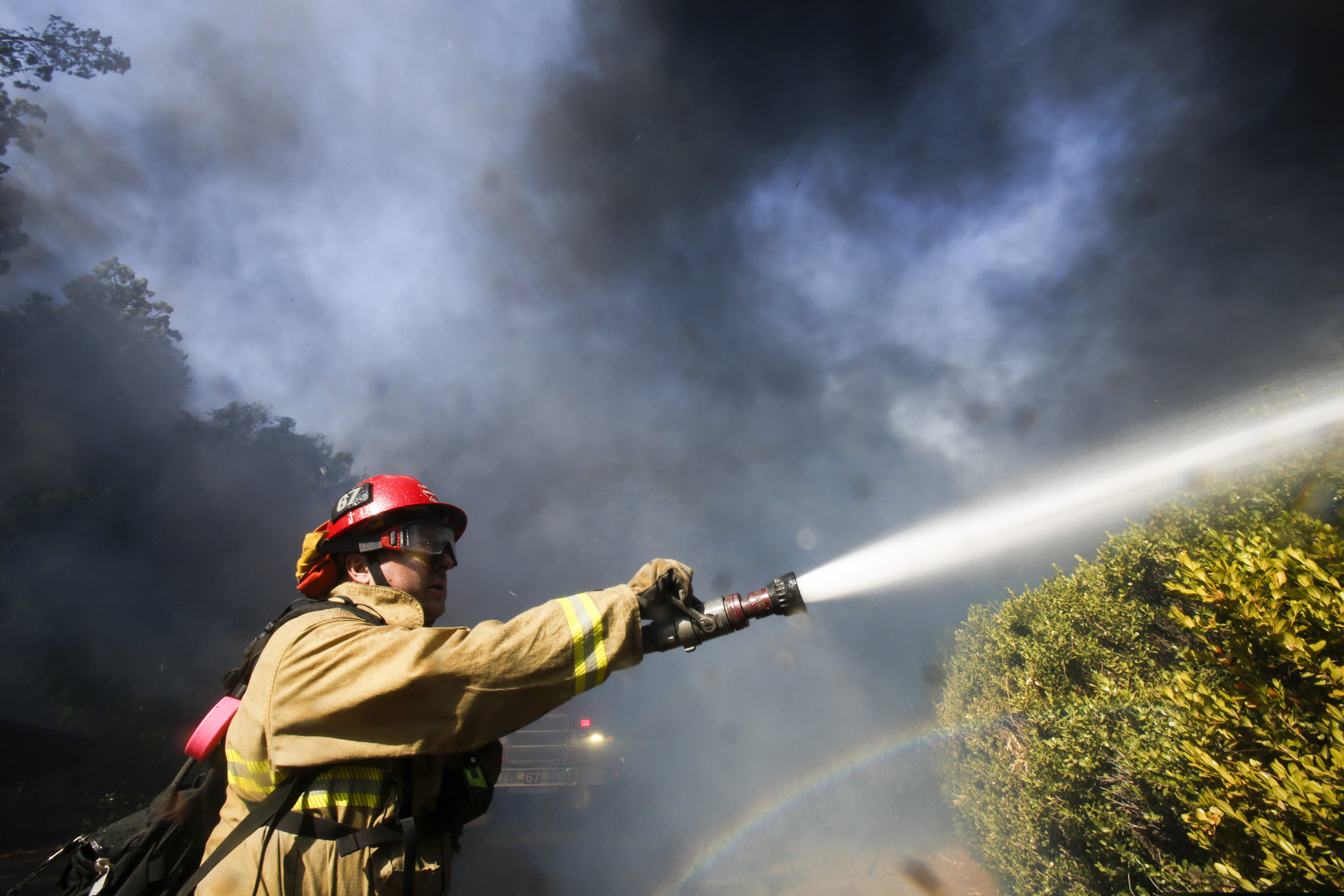 (Ringo H.W. Chiu | AP) A firefighter battles a wildfire near a ranch in Simi Valley, Calif., Wednesday, Oct. 30, 2019.  A new wildfire erupted Wednesday in wind-whipped Southern California, forcing the evacuation of the Ronald Reagan Presidential Library and nearby homes, as both ends of the state struggled with blazes, dangerously gusty weather and deliberate blackouts.