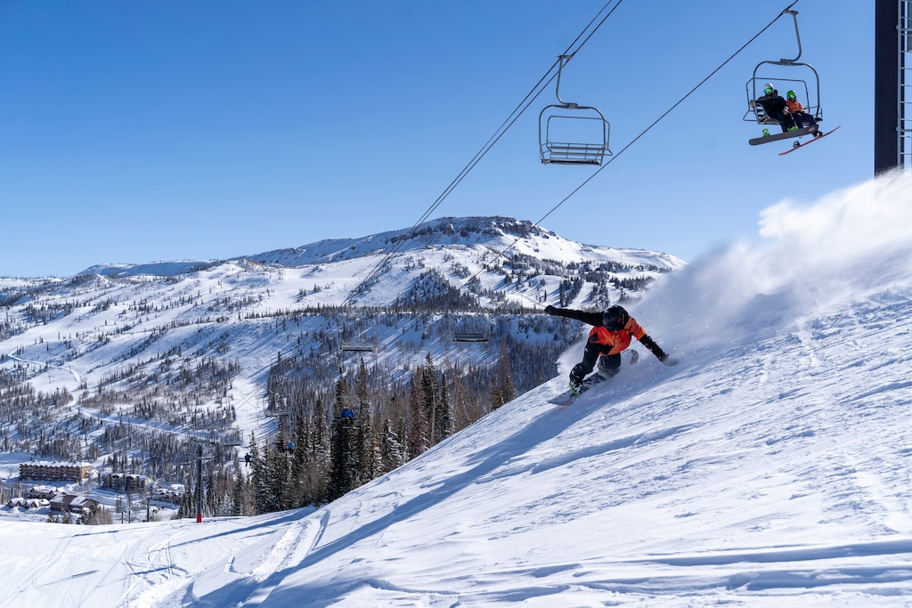 (Brian Head Resort) A snowboarder carves turns under a chairlift at Brian Head Resort near Cedar City. 