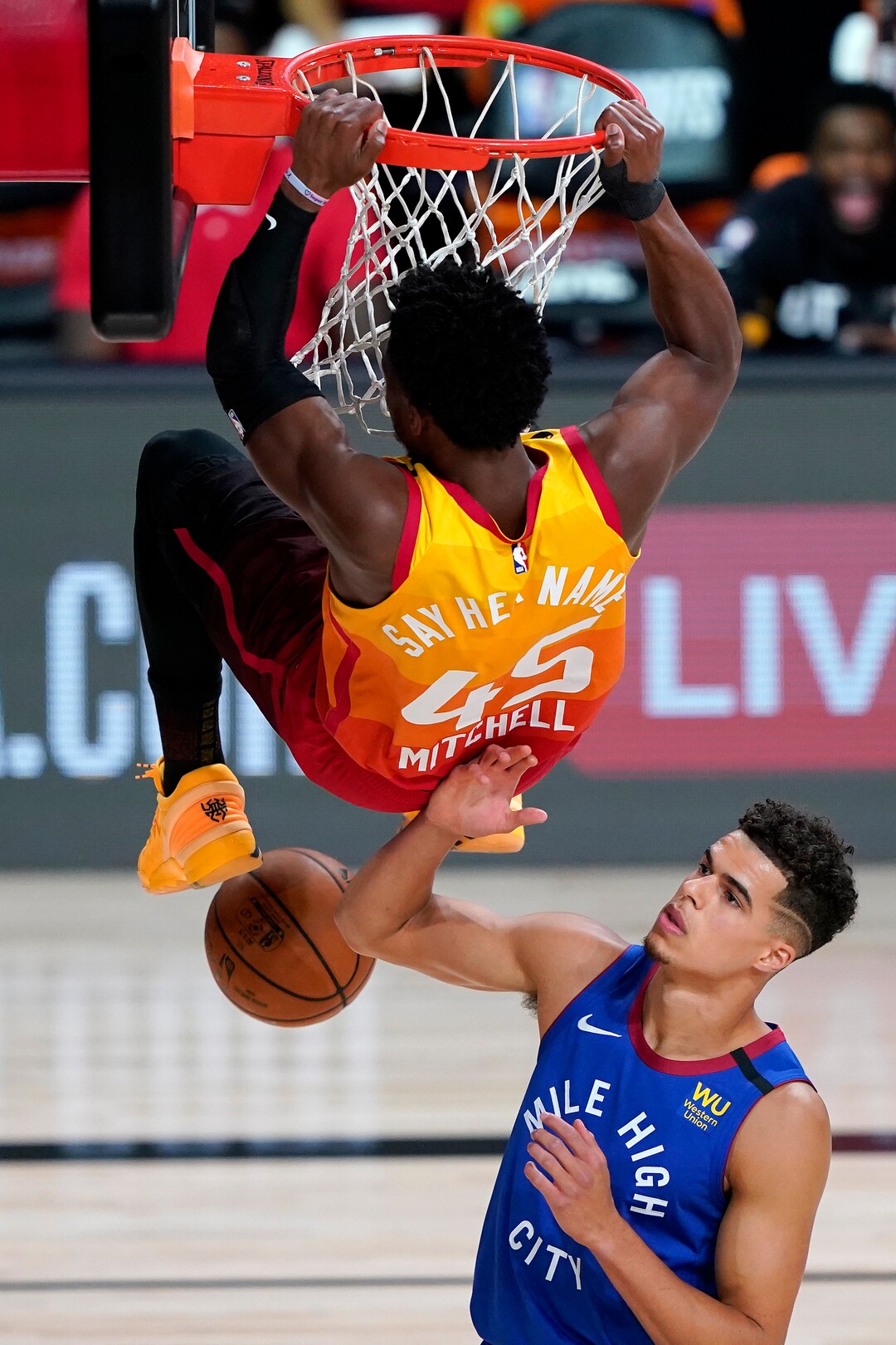 Utah Jazz's Donovan Mitchell (45) dunks over Denver Nuggets' Michael Porter Jr. during the first half of an NBA basketball first round playoff game Friday, Aug. 21, 2020, in Lake Buena Vista, Fla. (AP Photo/Ashley Landis, Pool)