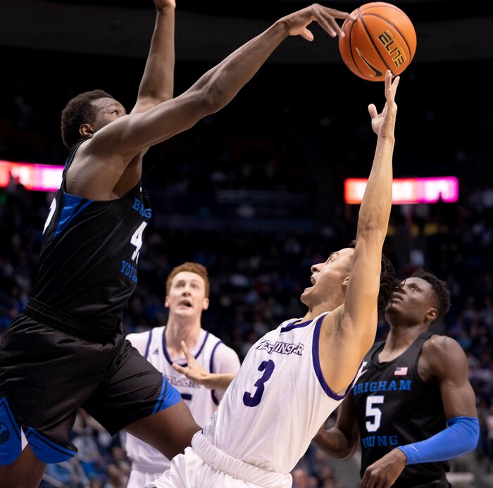 (Francisco Kjolseth | The Salt Lake Tribune) Brigham Young Cougars forward Fousseyni Traore (45) puts the block on Westminster Griffins guard Taylor Miller (3) in basketball action between the Brigham Young Cougars and the Westminster Griffins at the Marriott Center in Provo, Wednesday, Dec. 29, 2021.