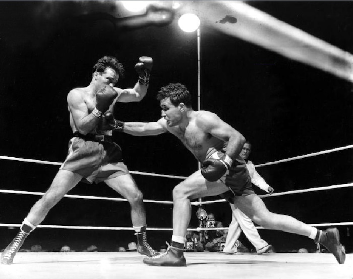 Associated Press File Photo. This June 16, 1949, file photo, shows Jake LaMotta, right, fighting Marcel Cerdan in Briggs Stadium in Detroit, Mich. LaMotta knocked out Cerdan in the tenth round to become the new world middleweight champion. LaMotta, whose life was depicted in the film “Raging Bull,” died Tuesday, Sept. 19, 2017, at a Miami-area hospital from complications of pneumonia. He was 95.