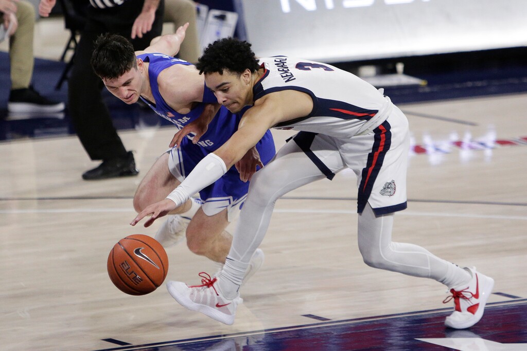 BYU guard Alex Barcello,left, and Gonzaga guard Andrew Nembhard go after the ball during the first half of an NCAA college basketball game in Spokane, Wash., Thursday, Jan. 7, 2021. (AP Photo/Young Kwak)