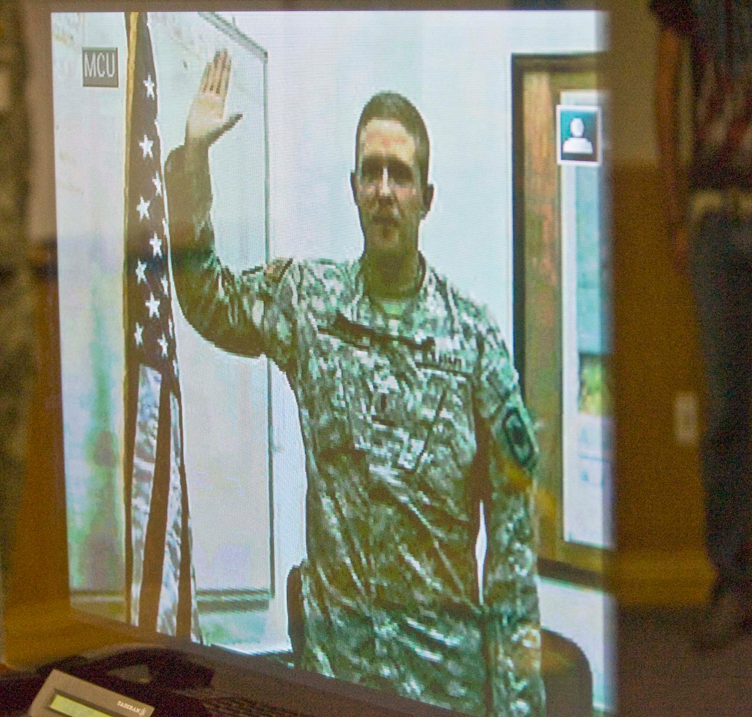 (Paul Fraughton  |  Tribune file photo) In this 2008 file photo, then-Utah Army National Guard 1st Lt. Brent Taylor, left, administers the oath of enlistment while in Iraq to his younger brother Travis Taylor, by way of a satellite feed. Brent Taylor died Nov. 3, 2018, while deployed to Afghanistan. Taylor was 39.