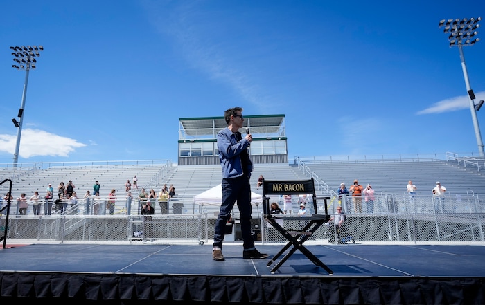 (Bethany Baker | The Salt Lake Tribune) Kevin Bacon speaks on stage during a charity event to commemorate the 40th anniversary of the movie "Footloose" on the football field of Payson High School in Payson on Saturday, April 20, 2024.
