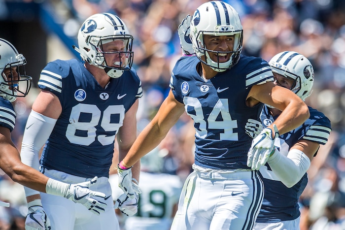(Chris Detrick  |  The Salt Lake Tribune) Brigham Young Cougars wide receiver Neil Pau'u (84) celebrates his touchdown with Brigham Young Cougars tight end Matt Bushman (89) and Brigham Young Cougars wide receiver Inoke Lotulelei (83) during the game at LaVell Edwards Stadium Saturday, August 26, 2017.