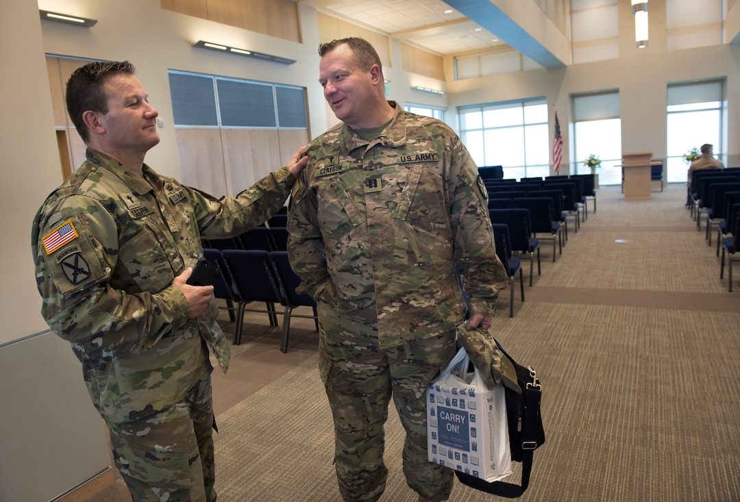 Scott Sommerdorf | The Salt Lake TribuneMaj. Tim Blatter, left speaks with Captain Tim Clayson - both chaplains - after an LDS service at the Camp Williams chapel, Sunday, March 4, 2018. Capt. Clayson is about to be deployed to the middle east,
