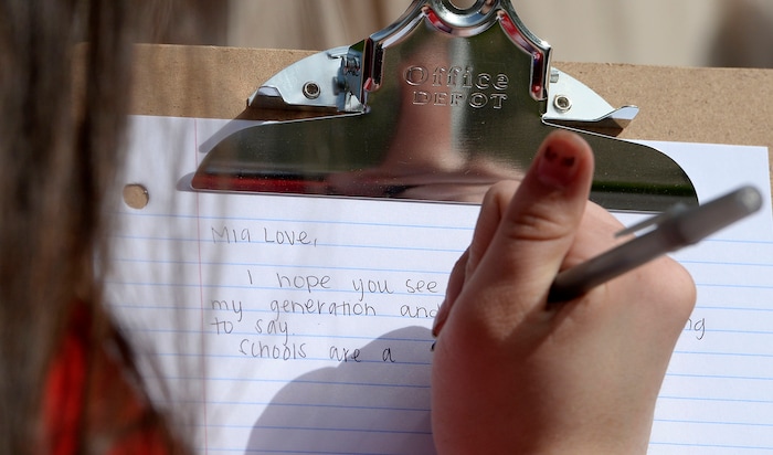 (Al Hartmann  |  The Salt Lake Tribune) 	
Highland High School studnt writes a letter to Congresswoamn Mia Love.  Over one hundred students at Highland High School staged a walkout Friday April 20, 2018 in honor of the anniversary of the Columbine High School massacre. Demonstrators walked from the school to Sugar House Park where they made posters, wrote letters to their congressmen and listened to speakers. 