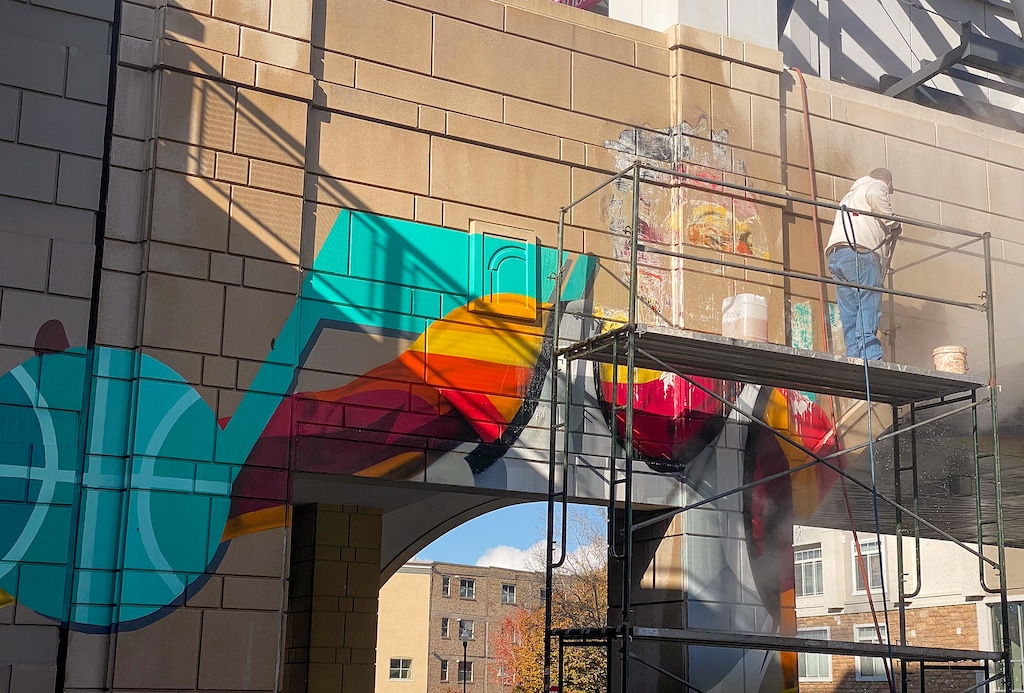 (Aaron Falk | The Salt Lake Tribune) A worker removes a mural of former Jazz guard Donovan Mitchell from a wall at the Gateway Mall on Thursday.