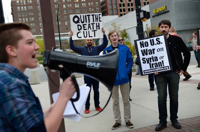 (Scott Sommerdorf | The Salt Lake Tribune)
Bryn Dayton speaks on the bullhorn as a group of about 40 people protested the strikes on Syria, Sunday, April 15, 2018.
