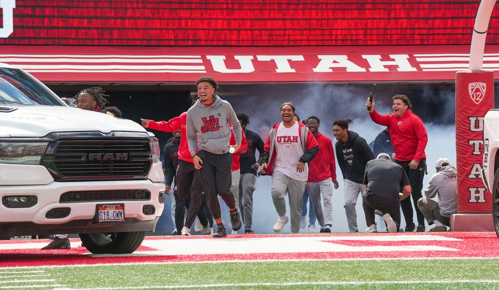 (Chris Samuels | The Salt Lake Tribune) Utah football players react at Rice Eccles Stadium after being given pickup trucks by the Crimson Collective name, image and likeness organization in Salt Lake City, Wednesday, Oct. 4, 2023.