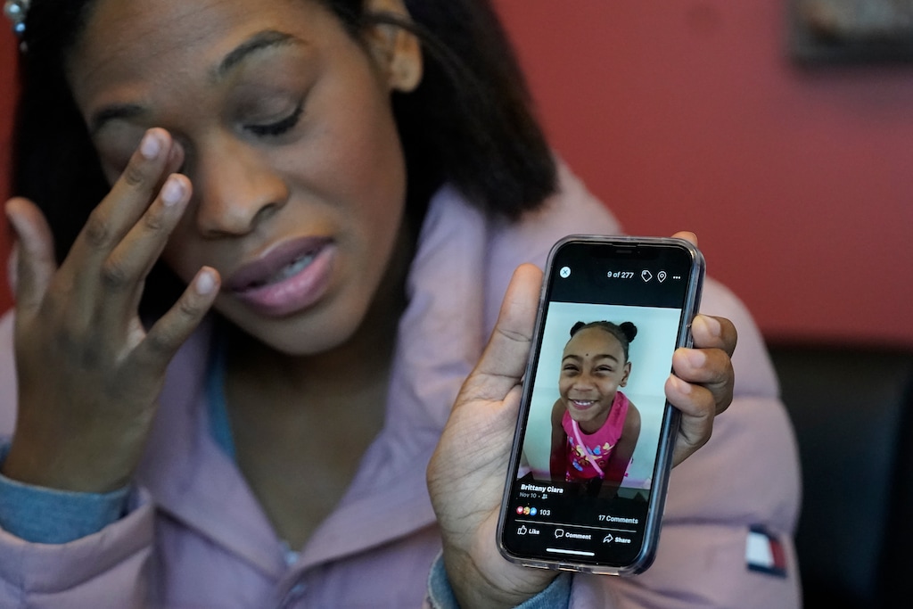 (Rick Bowmer | AP) Brittany Tichenor-Cox, holds a photo of her daughter, Isabella "Izzy" Tichenor, during an interview Monday, Nov. 29, 2021, in Draper, Utah. Tichenor-Cox said her 10-year-old daughter died by suicide after she was harassed for being Black and autistic at school. She is speaking out about the school not doing enough to stop the bullying.