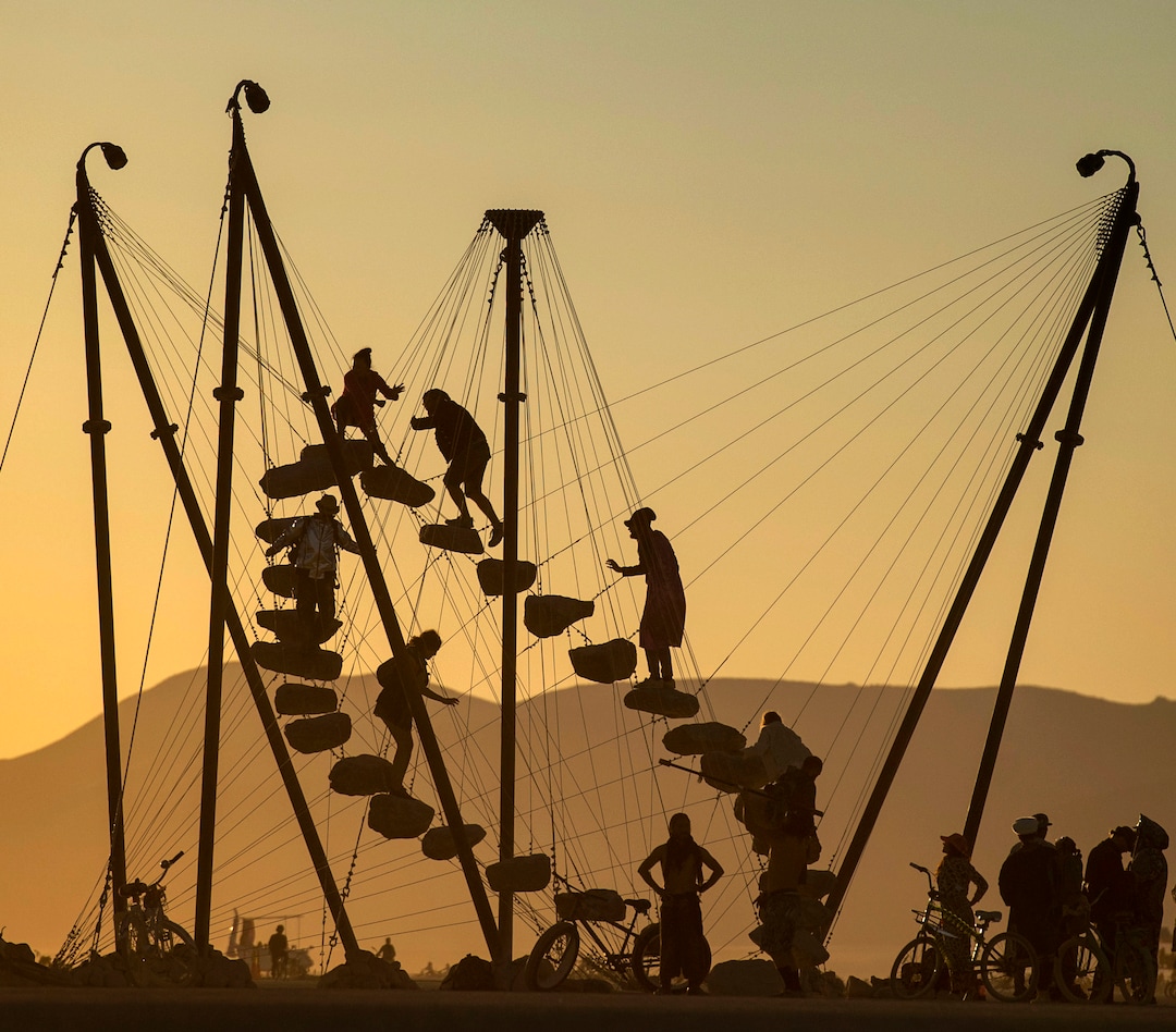 (Rick Egan  |  The Salt Lake Tribune)   Burning Man revelers climb the 27 floating stones on an art installation called "Stone 27" by Benjamin Langholz, at Burning Man, Saturday, Aug. 31, 2019.