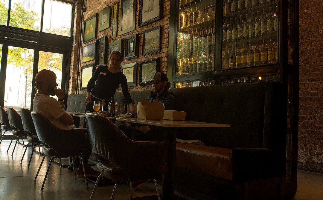 (Leah Hogsten  |  The Salt Lake Tribune) White Horse Spirits and Kitchen server Suzanne Palmer tends to customers Drew Tayler, left, and Steven Alexander.