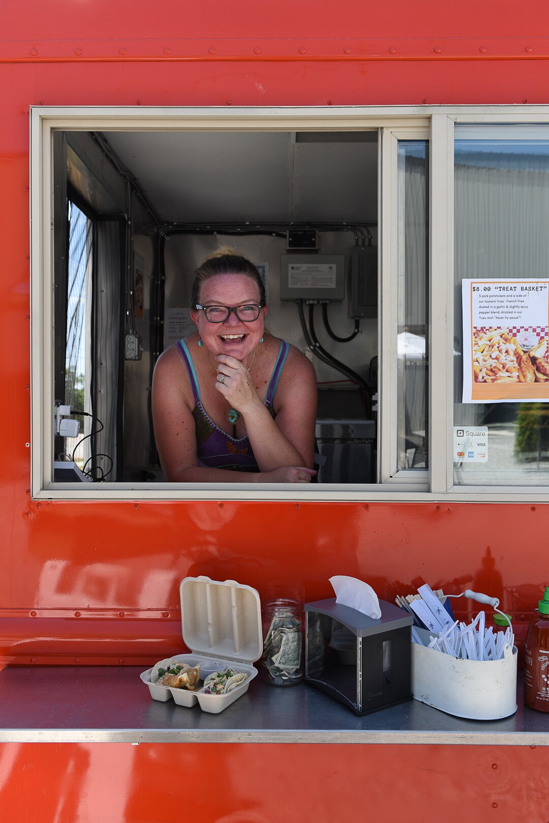 (Francisco Kjolseth  |  The Salt Lake Tribune)  Co-owner Amy Dunyon braves the heat inside the Umai food truck which serves Asian-style tacos, sliders and other street food.