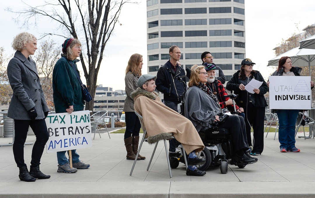 (Francisco Kjolseth  |  The Salt Lake Tribune)  A group of Utahns rally at the Wallace Bennett Federal Building in Salt Lake on Monday, Nov. 20, 2017, to tell personal stories of how they might be impacted by the tax reform plans currently on the table in Congress.