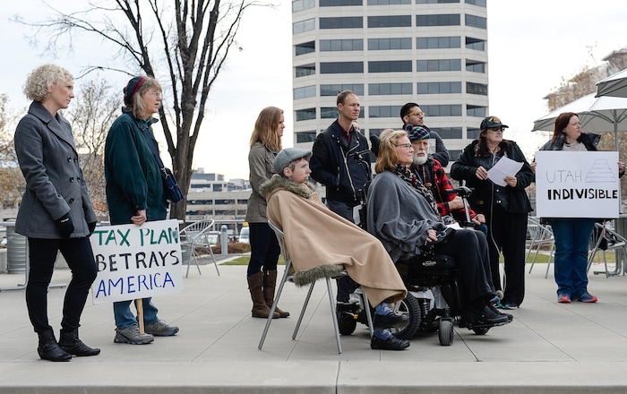 (Francisco Kjolseth  |  The Salt Lake Tribune)  A group of Utahns rally at the Wallace Bennett Federal Building in Salt Lake on Monday, Nov. 20, 2017, to tell personal stories of how they might be impacted by the tax reform plans currently on the table in Congress.