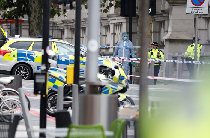 A forensic officer and two police women stand at the scene of an incident in central London, Saturday, Oct. 7, 2017. London police say emergency services are outside the Natural History Museum in London after a car struck pedestrians. (AP Photo/Kirsty Wigglesworth)