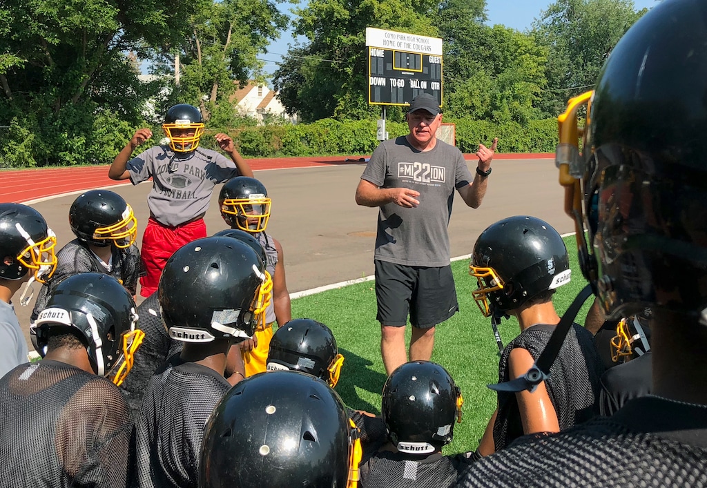 (Kyle Potter | AP) Tim Walz, then a candidate for Minnesota governor, gives a pep talk to football players at Como Park Senior High School in St. Paul on Monday, Aug. 13, 2018.