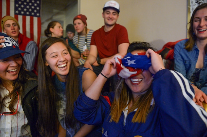 (Leah Hogsten | The Salt Lake Tribune) l-r Jocelyn Mendoza and Kira Tangite laugh at Sining Chan as she wraps her scarf around her head in anticipation of Darian Stevens' run. Westminster students and friends of first-time Olympian Darian Stevens gathered for a watch party in Sugar House to watch Stevens compete in her first qualifying ski slopestyle competition run Friday, Feb. 16, 2018. Stevens is a graduate of the Park City Winter Sports School and a business major at Westminster.