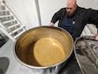 (Short Creek Spirits) Ray Hammon examines a fermenting tank at Short Creek Spirits in Colorado City, Ariz.