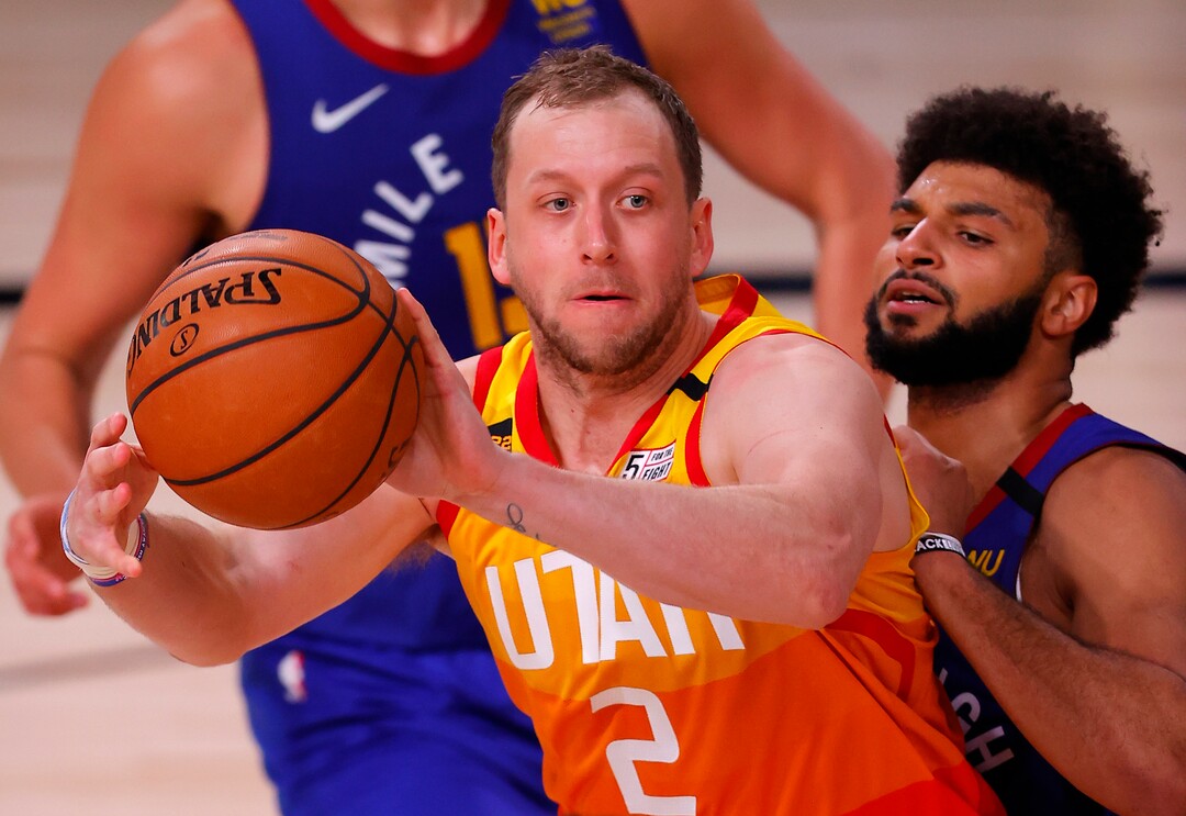 (Mike Ehrmann | Pool via AP) Utah Jazz's Joe Ingles (2) passes the ball againstDenver Nuggets' Jamal Murray during the third quarter of Game 3 of an NBA basketball first-round playoff series, Friday, Aug. 21, 2020, in Lake Buena Vista, Fla.