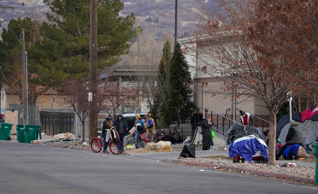 (Bethany Baker  |  The Salt Lake Tribune) People gather outside of Lantern House, a homeless shelter in Ogden that will open additional beds on “code blue” nights, on Thursday, Dec. 12, 2024.