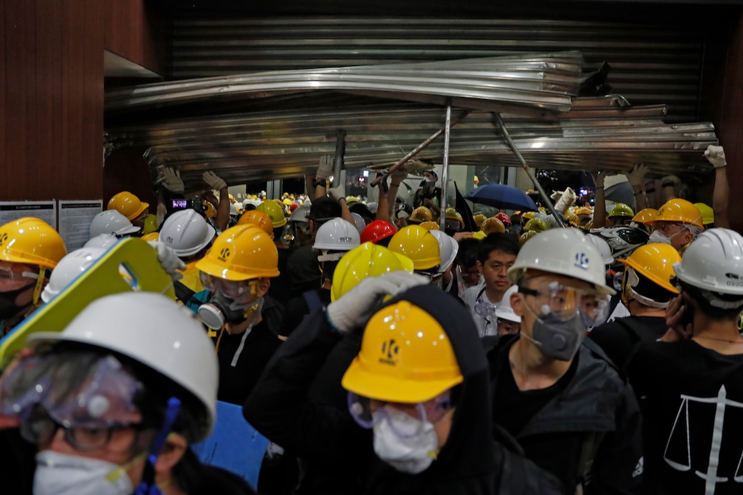 (Kin Cheung | AP Photo) Protesters break into the Legislative Council in Hong Kong, Monday, July 1, 2019.  Protesters in Hong Kong took over the legislature's main building Friday night, tearing down portraits of legislative leaders and spray painting pro-democracy slogans on the walls of the main chamber.