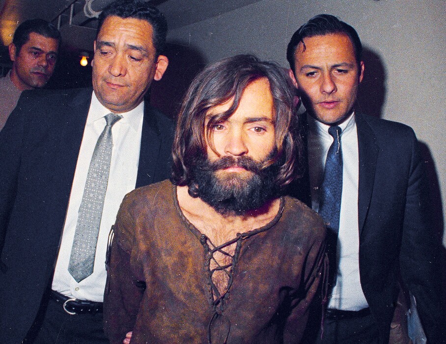 (AP Photo) In this 1969 photo, Charles Manson is escorted to his arraignment on conspiracy-murder charges in connection with the Sharon Tate murder case in Los Angeles. Fifty years ago Charles Manson dispatched a group of disaffected young hippie followers on a two-night killing spree that terrorized Los Angeles and in the years since has come to represent the face of evil. On successive nights in August 1969, the so-called Manson family murdered seven people.