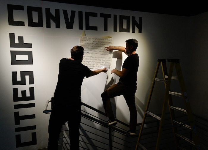 (Francisco Kjolseth | The Salt Lake Tribune) John Burdick, left, and Jared Steffensen put the finishing touches on a new exhibit at the Utah Museum of Contemporary Art entitled "Cities of Conviction," an exhibit of contemporary art by artists from Saudi Arabia.
