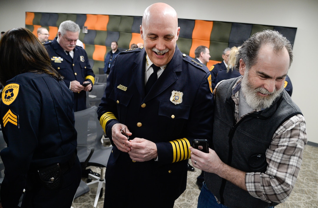 (Francisco Kjolseth  |  The Salt Lake Tribune)  Salt Lake City Police Chief Mike Brown is greeted by retired officer Troy Duke who spent 22-years in law enforcement as they attend the ceremony to retire the airport police patch and badge on Tuesday, Feb. 26, 2019. 