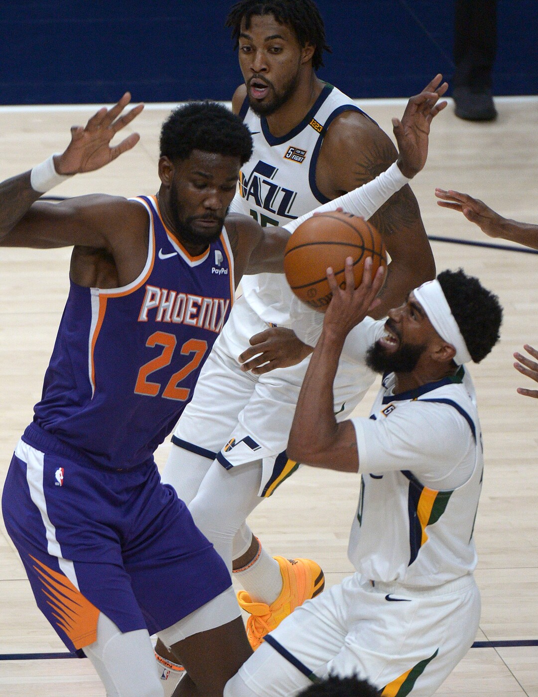 (Leah Hogsten  |  The Salt Lake Tribune) Utah Jazz guard Mike Conley (10) drives past Phoenix Suns center Deandre Ayton (22) as the Jazz crack open their 2020-21 preseason with their second game against the Phoenix Suns, Dec. 14, 2020.