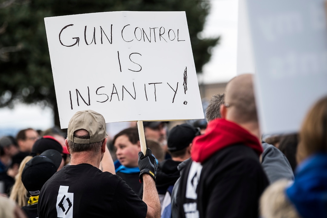 (Chris Detrick | The Salt Lake Tribune)  Participants hold signs during the March Before Our Lives rally near West High School in Salt Lake City Saturday, March 24, 2018.