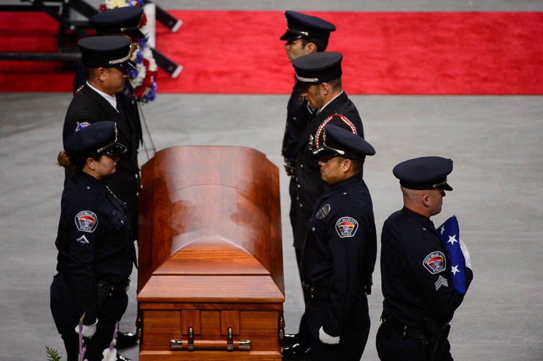(Trent Nelson | The Salt Lake Tribune)  West Valley City police officers perform a flag presentation for family members at funeral services for Jill Robinson, a West Valley City code-enforcement officer killed on the job last week. The service took place at the Maverik Center in West Valley City on Friday Aug. 17, 2018.