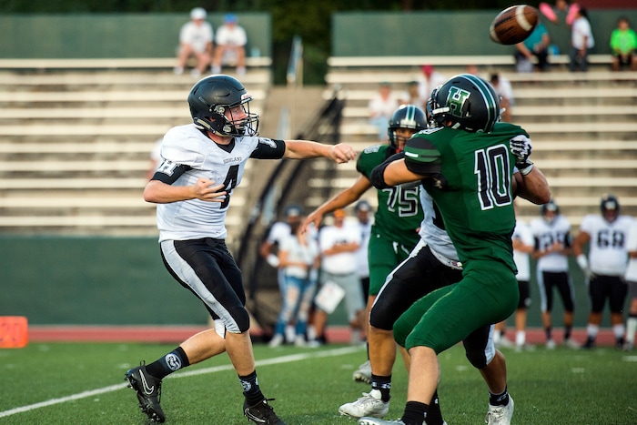 (Chris Detrick  |  The Salt Lake Tribune)    Highland's Cole Peterson (4) passes over Hillcrest's Jordan Dunn (10) during the game at Hillcrest High School Friday, September 1, 2017. 