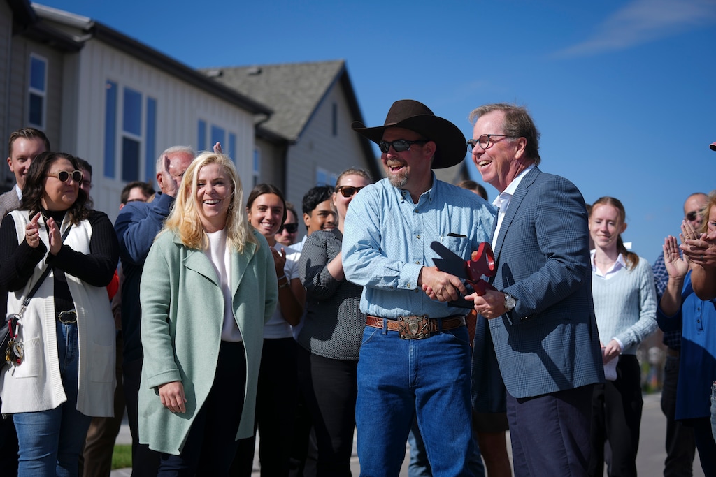 (Bethany Baker | The Salt Lake Tribune) Francis Mayor Jeremie Forman, left, and Clark Ivory, right, CEO of Ivory Homes shake hands following a ribbon cutting during the grand opening ceremony for Innovation Park at Francis Commons, a housing development with townhomes priced 40% below market rate, in Francis on Tuesday, Sept. 16, 2025.