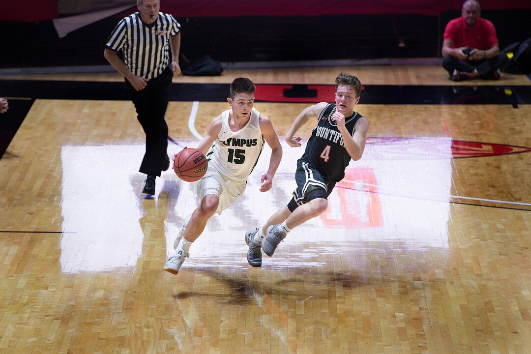 Scott Sommerdorf | The Salt Lake TribuneOlympus' Rylan Jones bring up the ball against David Stevenson of Bountiful during first half play. Olympus beat Bountiful 79-43, in a boy's 5A semi-final, FrIday, March. 2, 2018.